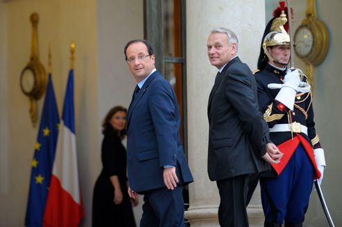 French President Francois Hollande walks with Prime Minister Jean-Marc Ayrault at the Elysee Palace in Paris